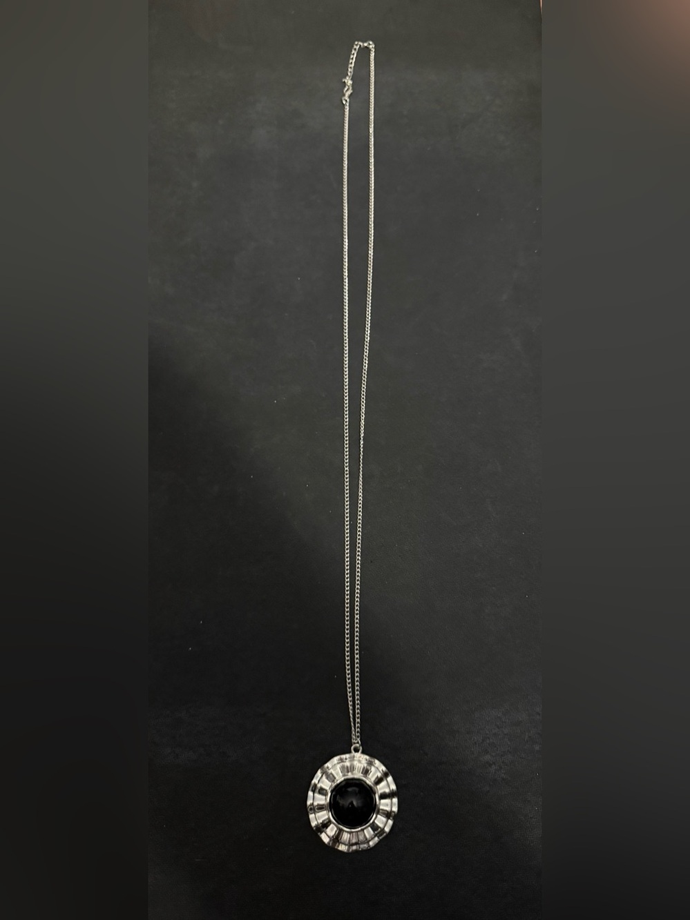 Silver Tone Necklace With A Circular Pendant